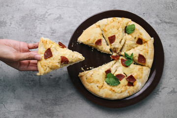Top View Of Hand Taking Slice Pizza Isolated On Grey Background