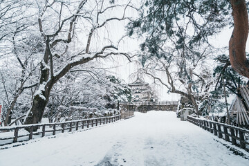 White Hirosaki Castle or Takaoka Castle with snow in winter, hirayama style Japanese castle located...