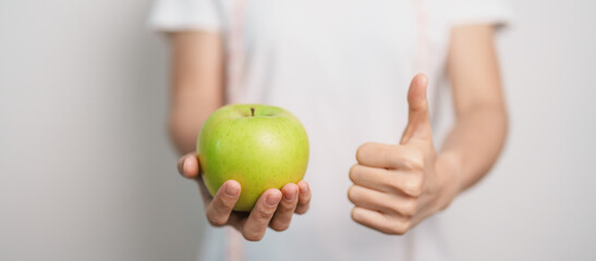woman hand hold green Apple, happy female fitness choose fruit is Healthy food. Dieting control,...