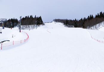 Ski field large white snow on slopes. Tourists come to play winter sports. Ski slopes snow. Winter...