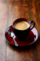 Cup of coffee on wooden background. Close up.	