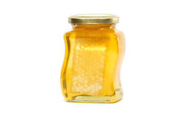 Glass jar filled with honey and honeycomb isolated on white