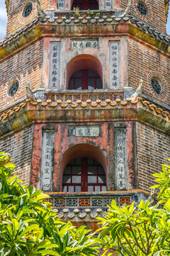 Looking up at a multi levelled pagoda with ornate brickwork and tiling at Hue in Vietnam