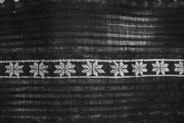 A black and white photo of a piece of fabric with a white stripe