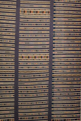 A colorful striped rug with a blue stripe