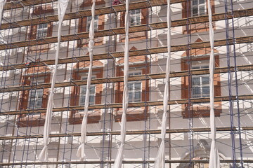 Workers on scaffolding at the construction site of a new building 2