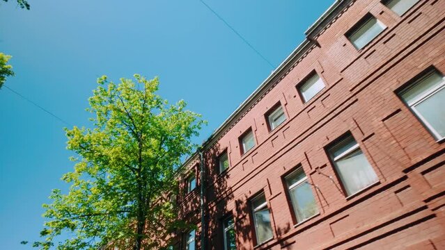 Sunlight reflecting in windows of neoclassical red brickstone building in Central Europe