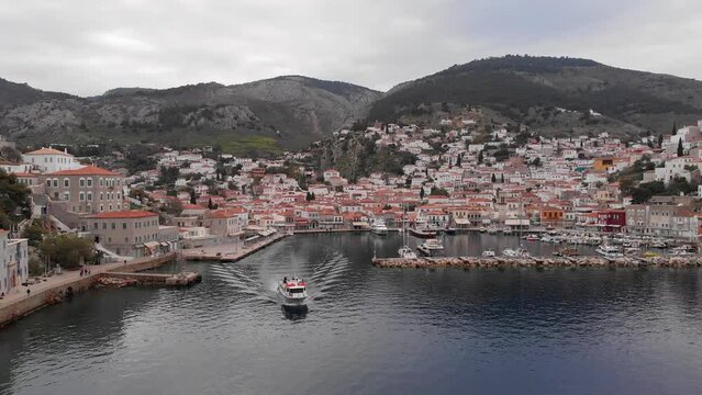 Ferry Boat Leaving The Port Of Hydra Town In Saronic Islands Of Greece, Aegean Sea. Aerial Shot