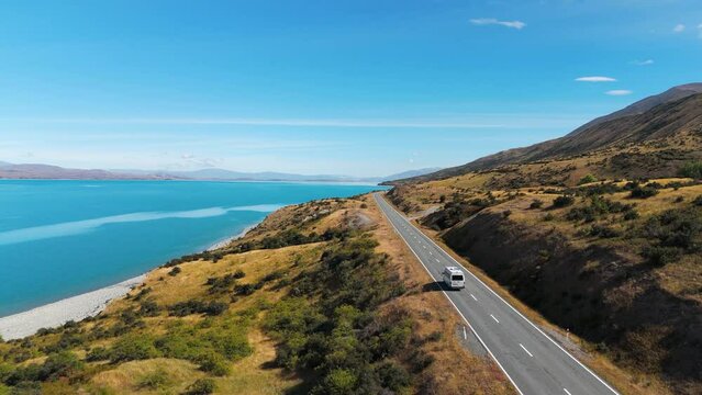 Van Driving On Road Near Lake Pukaki On South Island Of New Zealand. drone following shot
