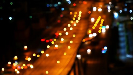 Blurred background night city bokeh car drive on road in nightlife. Light line traffic jam in black...
