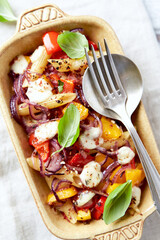 Penne pasta baked with peppers, red onion and mozzarella. Top view.	