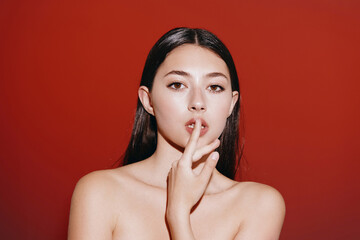 Silent Beauty: Young, Attractive Woman with a Cute Gesture, Secretly Keeping Her Lips Sealed.