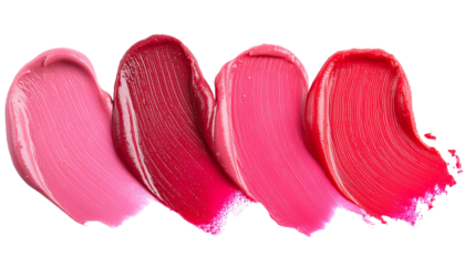 Four creamy lipstick streaks in different shades of pink and red are smudged on a white background