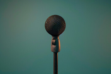 A sleek black microphone with a silver mesh head stands isolated against a background, ready to capture vocals for recording