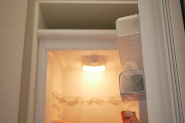 half open fridge with food and vegetables ,