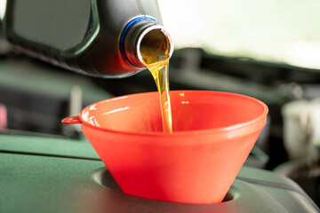 Refueling and pouring oil quality into the engine motor car Transmission and Maintenance Gear...