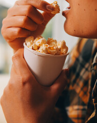 A woman holding a bowl of popcorn