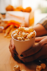 A woman holding a bowl of popcorn