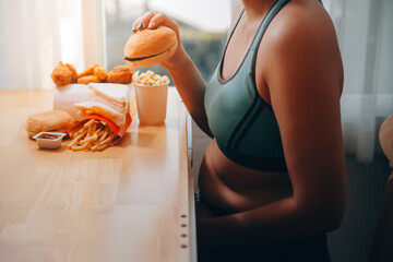 Binge eating disorder concept with woman eating fast food burger, fired chicken , donuts and...
