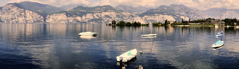 Alpine Panorama on Lake Garda in Italy with Few Moored Boats Before the Start of the Holiday Season
