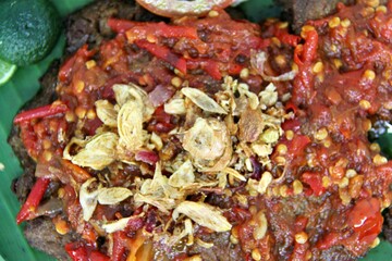 Empal Penyet consists of deep-seated beef cooked with kitchen spices such as bay leaves, galangal, lime leaves, tamarind, shallots, garlic, and many more.