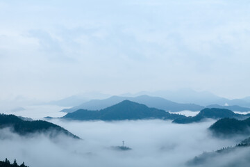 Majestic Chinese Mountains: Aerial Perspective of Misty Peaks and Cloud-Covered Valleys