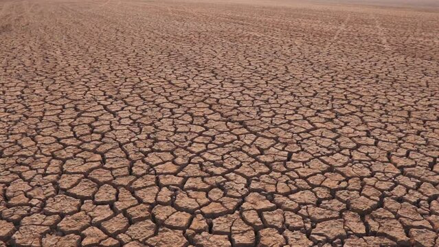 Draught land of Kutch desert. Natural pattern of desert land. Cracked, dry soil due to lack of water and hot weather in Little Rann of Kutch, Gujarat. Dehydrated and barren land during summer season