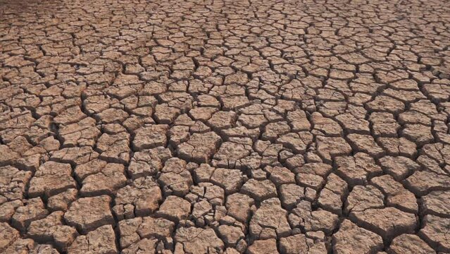 Draught land of Kutch desert. Natural pattern of desert land. Cracked, dry soil due to lack of water and hot weather in Little Rann of Kutch, Gujarat. Dehydrated and barren land during summer season