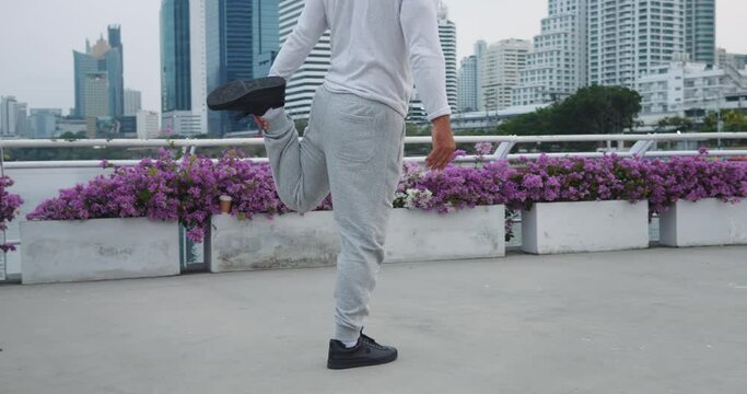 Older man doing pre-exercise routine warming up muscles dynamic stretches mobility exercises urban park. Ritual of body warm-up paramount serving as foundation for safe and effective workout session.