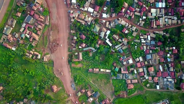 Kampala-Entebbe Expressway, Uganda, East Africa - Cars Traveling Along the Bustling Highway Near a Residential Community - Bird's Eye View