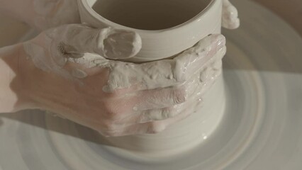 a female ceramicist working on the wheel