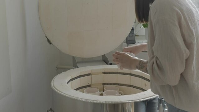 a female ceramicist loading the kiln
