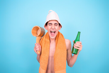 Healthy lifestyle. Retro style. A young attractive man is steaming in a Finnish sauna. Blue...