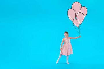 girl in pink dress with drawing balloons running on blue backgroundwith copy space	