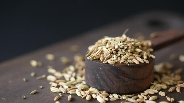 cumin seeds on spoon on table , close up 
