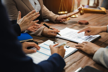 Teamwork of business lawyer meeting working hard about legal legislation in courtroom to help their customer..