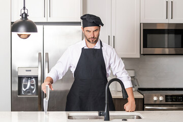 Man in chef hat cooking on kitchen.