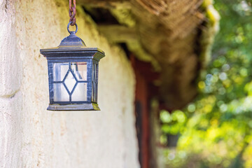 Lantern hanging by an old barn