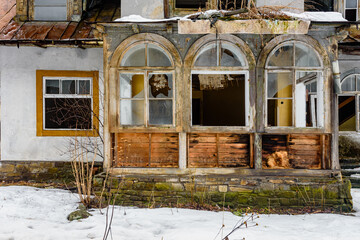 Part of old destroyed abandoned countryside mansion with veranda. A fragment of a forsaken vintage...