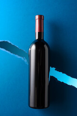 Bottle of red wine on a dark blue background.