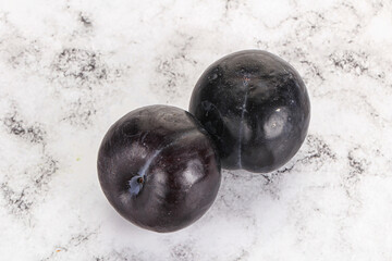 Two ripe sweet black plums