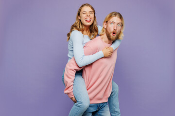 Young surprised couple two friend family man woman wear pink blue casual clothes together giving...