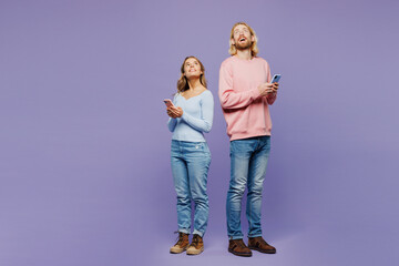 Full body young couple two friends family man woman wear pink blue casual clothes together hold in...