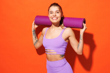 Young confident happy fitness trainer instructor sporty woman sportsman wear purple top clothes...