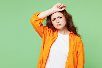 Young sick ill tired sad ginger woman she wearing orange shirt white t-shirt casual clothes putting...