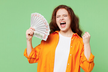 Young ginger woman she wear orange shirt white t-shirt casual clothes hold in hand fan of cash...