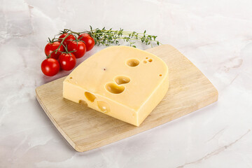 Maasdam cheese brick over board