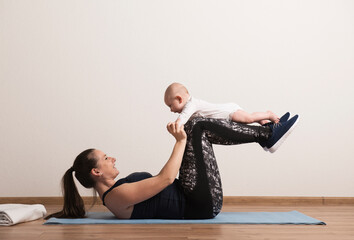 Home exercise for mother and baby, mommy and me workout. Physical activity for mother while bonding...