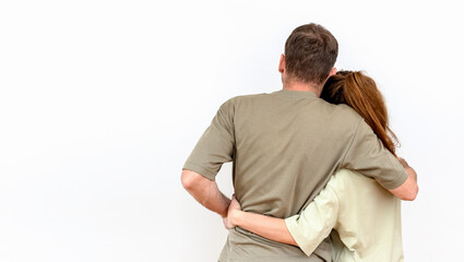 Fototapeta premium Rear view of caucasian heterosexual hugging couple isolated on white background.