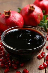 Pomegranate molasses and sour sauce with ripe fruits on table for a flavorful culinary experience